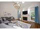 Inviting living room with a fireplace, large windows, and a comfortable seating area at 306 Lochside Dr, Cary, NC 27518