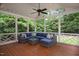 Relaxing screened porch with comfortable seating, string lights, and view of lush greenery at 306 Lochside Dr, Cary, NC 27518