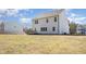 Home back exterior with expansive yard, deck, and view of neighboring houses at 31 E Dentaires Way, Willow Springs, NC 27592