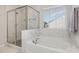 Elegant bathroom featuring a soaking tub, separate shower, and luxurious marble tile at 31 E Dentaires Way, Willow Springs, NC 27592