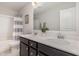 Bathroom featuring a dual-sink vanity with dark cabinetry and a framed mirror, complemented by tub with shower at 31 E Dentaires Way, Willow Springs, NC 27592