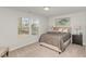 Bright bedroom featuring neutral tones, plush carpeting, and a window offering pleasant outdoor views at 31 E Dentaires Way, Willow Springs, NC 27592
