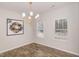 Bright dining room with wood floors, a modern chandelier, and ample natural light at 31 E Dentaires Way, Willow Springs, NC 27592