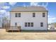 Back exterior view of home, featuring a deck, white siding, windows, and a spacious lawn at 31 E Dentaires Way, Willow Springs, NC 27592