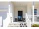Inviting front entrance featuring stone steps, white railing and a black front door at 31 E Dentaires Way, Willow Springs, NC 27592