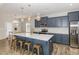 Stylish kitchen with a large island, seating, modern pendant lighting, and ample cabinetry at 31 E Dentaires Way, Willow Springs, NC 27592
