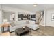 Open-concept living area with wood floors and seamless flow to the adjacent kitchen at 31 E Dentaires Way, Willow Springs, NC 27592