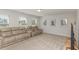 Spacious living room with plush theater seating and ample natural light from large windows at 31 E Dentaires Way, Willow Springs, NC 27592