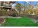 Landscaped backyard with a stone walkway and wooden stairs leading to a higher level at 3308 Forest Mill Cir, Raleigh, NC 27616