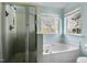 Bathroom featuring a glass shower, tub under the window and toilet at 3308 Forest Mill Cir, Raleigh, NC 27616