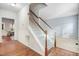 View of the entryway featuring a staircase with carpeted steps, light walls, and hardwood floors at 3308 Forest Mill Cir, Raleigh, NC 27616