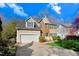 Two-story home with attached garage, brick and siding exterior, with a well-maintained lawn and landscaping at 3308 Forest Mill Cir, Raleigh, NC 27616