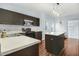 Open kitchen with dark cabinets, stainless appliances, an island, and breakfast bar at 3308 Forest Mill Cir, Raleigh, NC 27616