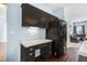 Kitchen with black refrigerator, cabinets, built-in desk and wood-look floors at 3308 Forest Mill Cir, Raleigh, NC 27616