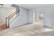 Bright living room with neutral carpet, light walls, and a staircase leading to the upper level at 3308 Forest Mill Cir, Raleigh, NC 27616