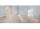 Open-concept living space with neutral carpet, light walls, and an open view of the dining area at 3308 Forest Mill Cir, Raleigh, NC 27616