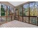 Inviting screened-in porch featuring a wooden floor and views of the surrounding trees at 3308 Forest Mill Cir, Raleigh, NC 27616