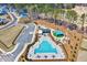 Aerial view of the community pool featuring ample lounge seating, a play area, and parking at 3417 Mission Olive Pl, New Hill, NC 27562