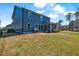 Spacious backyard with a well-maintained lawn, screened porch, and tasteful landscaping at 3417 Mission Olive Pl, New Hill, NC 27562