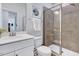 Well-lit bathroom featuring a vanity, toilet, and glass-enclosed shower with neutral tones at 3417 Mission Olive Pl, New Hill, NC 27562