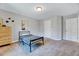 Simple bedroom with neutral tones, a bed, and a window allowing for ample natural light and closet doors at 3417 Mission Olive Pl, New Hill, NC 27562