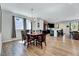 Cozy dining room with natural light and hardwood floors, adjacent to a kitchen at 3417 Mission Olive Pl, New Hill, NC 27562