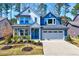 Beautiful two-story home boasts a well-manicured lawn, charming curb appeal, and an attached two-car garage at 3417 Mission Olive Pl, New Hill, NC 27562