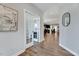 Inviting hallway with hardwood floors, neutral walls, leading to a kitchen with island seating at 3417 Mission Olive Pl, New Hill, NC 27562