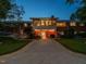 Backyard view showcasing a two-story brick home with a patio and lush landscaping at 3680 15-501 N, Pittsboro, NC 27312