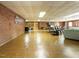 Spacious basement with brick accents and laminate wood flooring at 3680 15-501 N, Pittsboro, NC 27312