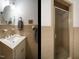 Bathroom with tile floors and walls, vanity, sink, mirror, and glass enclosed shower at 3680 15-501 N, Pittsboro, NC 27312
