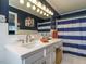 Stylish bathroom with blue walls, white tile, a large mirror, and vanity at 3680 15-501 N, Pittsboro, NC 27312