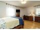 Cozy bedroom featuring wood floors, a wooden dresser, and a comfortable bed with blue accents at 3680 15-501 N, Pittsboro, NC 27312