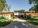 View of the home's exterior featuring a large lawn, covered deck, and convenient driveway at 3680 15-501 N, Pittsboro, NC 27312