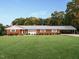 Charming brick ranch with a well-manicured lawn and a convenient covered carport at 3680 15-501 N, Pittsboro, NC 27312