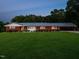 Charming brick home with a metal roof, lush lawn, and a long carport at 3680 15-501 N, Pittsboro, NC 27312