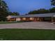 Wide view of a charming brick home with an attached carport and a spacious driveway at 3680 15-501 N, Pittsboro, NC 27312