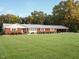 Charming brick ranch with a well-manicured lawn and a convenient covered carport at 3680 15-501 N, Pittsboro, NC 27312