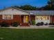 Inviting front entrance with a well-lit doorway, brick steps, and manicured landscaping at 3680 15-501 N, Pittsboro, NC 27312