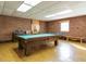 Spacious game room with a pool table, brick walls, and natural light from the window at 3680 15-501 N, Pittsboro, NC 27312