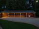 Long garage with string lights and attached basketball court is perfect for sports and entertaining at 3680 15-501 N, Pittsboro, NC 27312