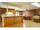 Spacious kitchen featuring a large kitchen island, a dining table, and brick accents at 3680 15-501 N, Pittsboro, NC 27312