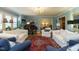 Spacious living room featuring classic furniture, a piano, and an ornate area rug at 3680 15-501 N, Pittsboro, NC 27312