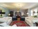 Comfortable living room showcasing a chandelier, ample seating, and an elegant area rug at 3680 15-501 N, Pittsboro, NC 27312