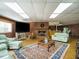 Open living room features a brick fireplace, wood floors, and comfortable seating around a decorative rug at 3680 15-501 N, Pittsboro, NC 27312