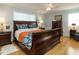 Well-lit bedroom with wooden floors, nightstands, and a large bed at 3680 15-501 N, Pittsboro, NC 27312