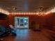 Enclosed patio features string lights, ceiling fans, unique floor tiles, and comfortable seating at 3680 15-501 N, Pittsboro, NC 27312