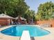 Beautiful in-ground pool featuring diving board, lounge seating, and adjacent pool house at 3680 15-501 N, Pittsboro, NC 27312