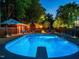 Inviting in-ground pool with diving board, poolside seating, and adjacent pool house with bathroom at 3680 15-501 N, Pittsboro, NC 27312