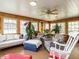 Bright sunroom with wood paneled walls, ceiling fan, ample windows, and seating at 3680 15-501 N, Pittsboro, NC 27312